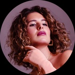 Femme-presenting person Pronouns: she/her Long curly dark hair Brown eyes